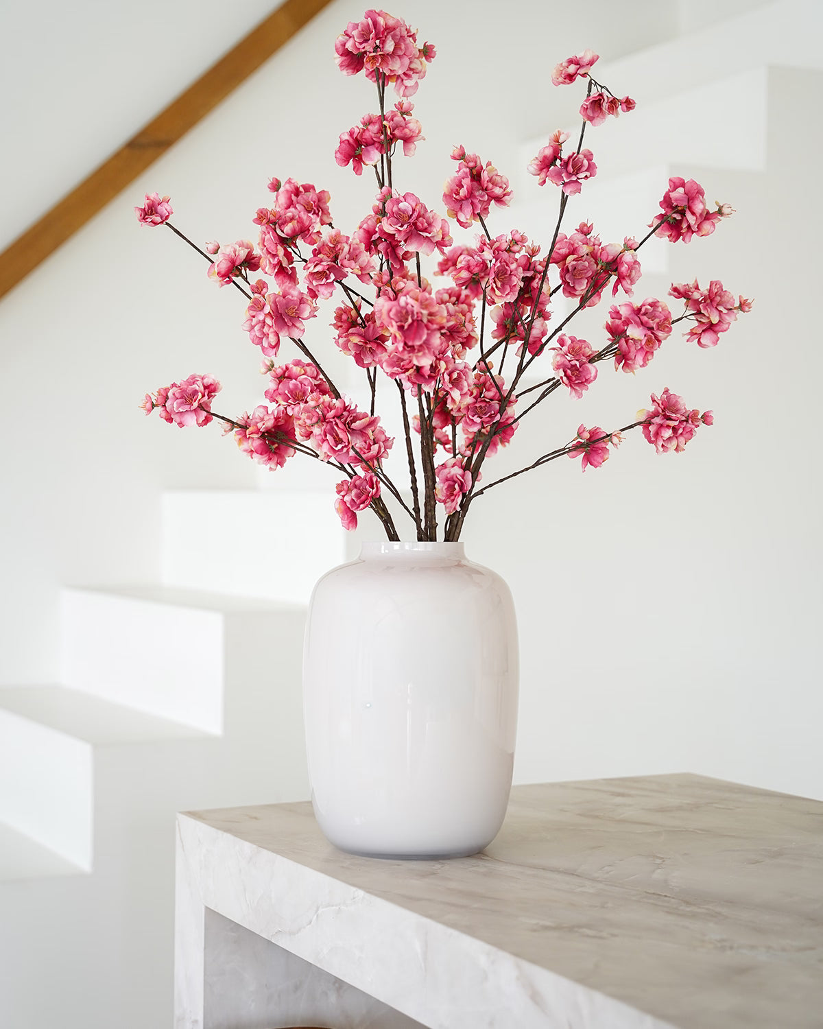 Donkerroze zijden bloesem takken in lichte Vaas Crema M van Fan of Flowers